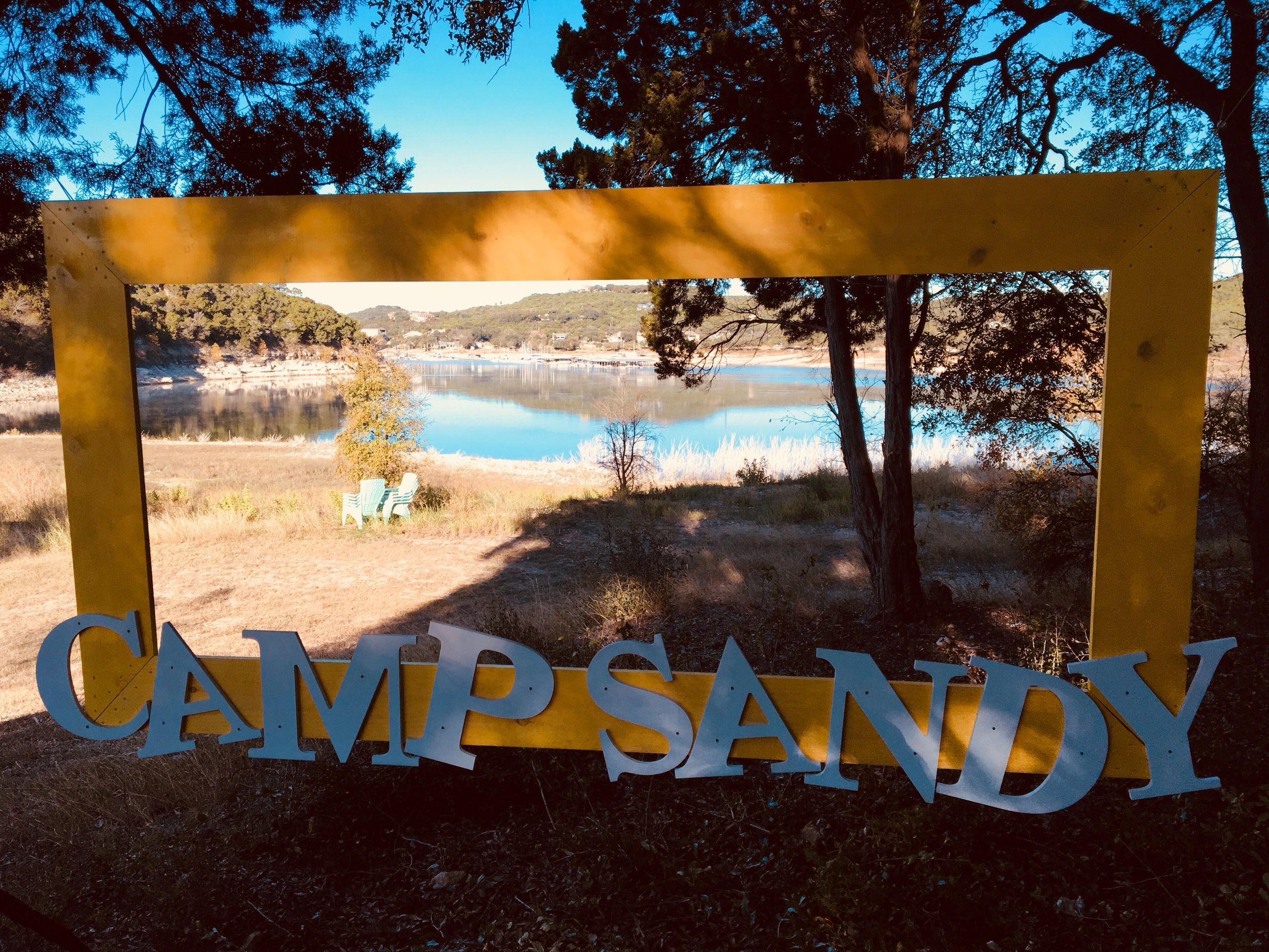 Camp Sandy sign by lake
